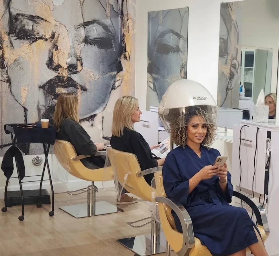 Salon interior showing styling stations and reception at Glow Hair Studio