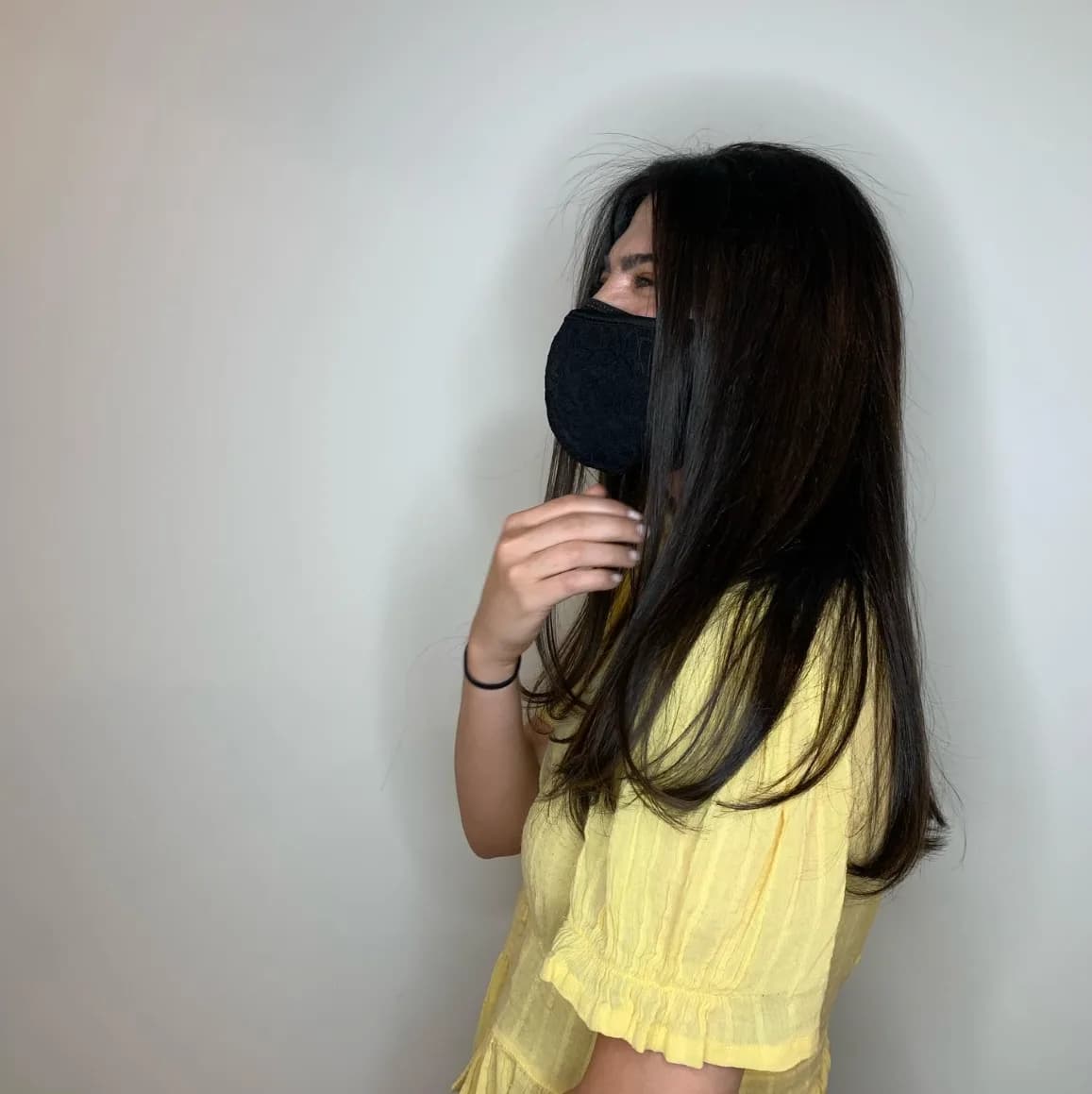 Layered brunette haircut with soft waves styled by Linet at Glow Hair Studio