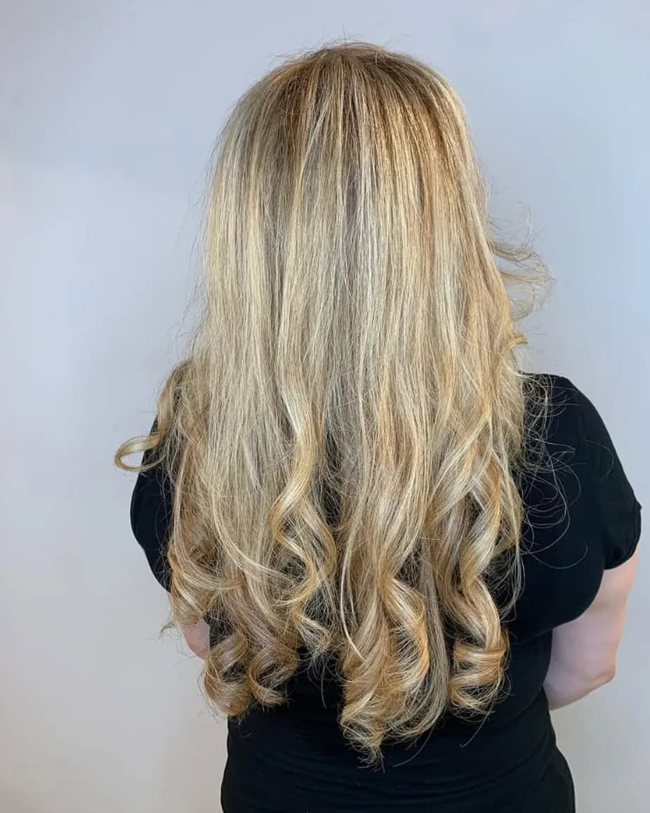 Warm caramel balayage and face-framing highlights on long hair at Glow Hair Studio